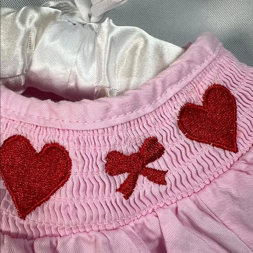 Boutique pink smocked bubble romper with hearts and bows embroidery size 3 month